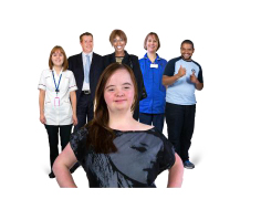Person standing in front of a group of people who work in the care services 