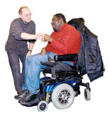Man in a wheelchair chatting to another man