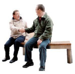 Two men sitting on a bench shaking hands