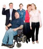 Family and carers with man in a wheelchair