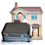 Man with a suitcase infront of a house