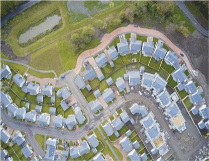An overhead image of a typical housing development, showing houses, streets and greenspace.