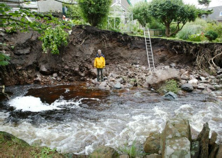 Following a burn in spate in the Highlands severe erosion occurred adjacent to houses where the burn edge and training walls had been eroded
