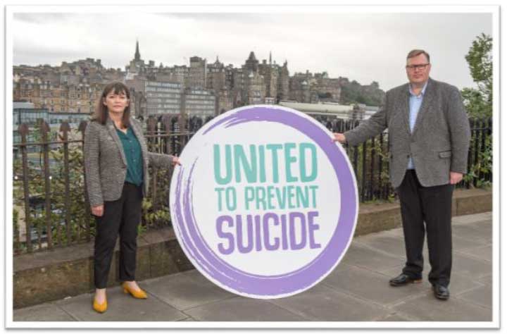 Clare Haughey MSP and Councillor Stuart Currie holding United to Prevent Suicide logo