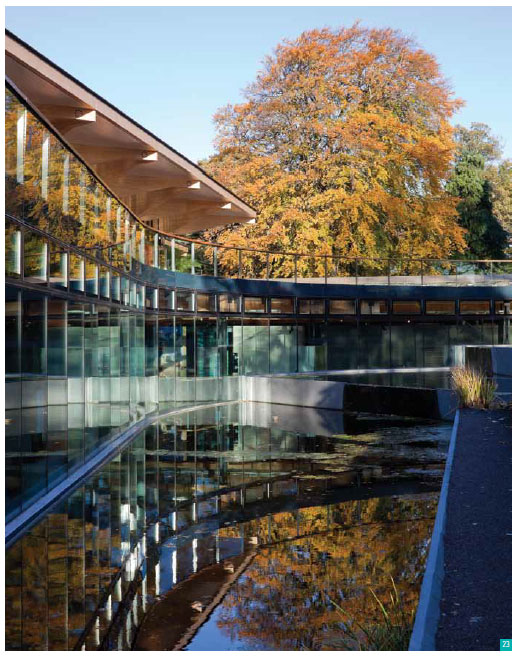 Image 15: building and trees reflecting in water
