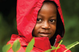 Child wearing a red jacket with their hood up