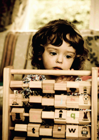 Child with wooden toy