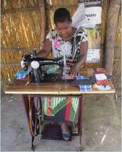 Patuma - one of the women involved in manufacturing reusable sanitary towels at the  Fistula Care Centre at Bwaila Hospital in Lilongwe - demonstrates her sewing machine.