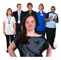 A person stands confidently in front of a range of staff