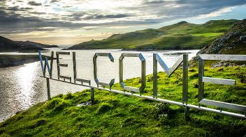 Welcome sign in a Scottish landcscape