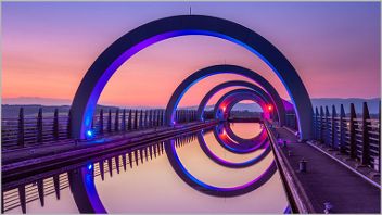 A view of the Falkirk wheel with a purple dusky sky.