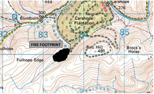 Fig. B7.12 The fire has developed a strong head and its forward motion is upwards along the valley. The steep slopes either side provide alignment for lateral movement by both flanks.