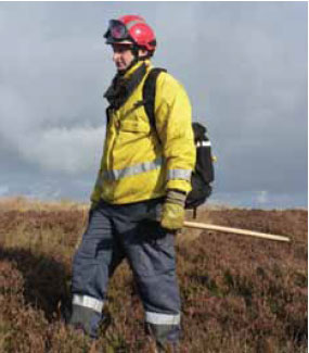 Photo B10.6 Showing a firefighter correctly carrying a polaski