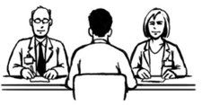 A man sitting at a desk with two officials