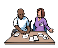 A man in a wheelchair using low tech communication equipment to make decisions. A professional woman is sitting next to him and watching him make his choice.