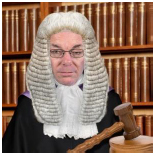 Picture of a judge with a gavel in front of him, with rows of law books in the background 