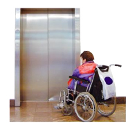 Person in a wheelchair waiting outside a lift