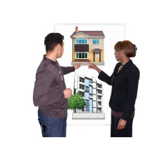 Two people who are looking at a picture which has a house and a block of flats. They are both looking and pointing at the house.