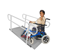 Person in a wheelchair who is starting to go up a ramp