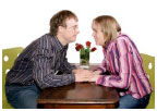 Two people holding hands over a table