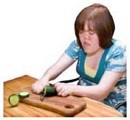 person chopping a cucumber