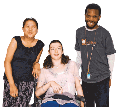 Two people standing either side of someone in a wheelchair