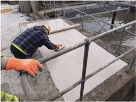 Image showing a man applying low-carbon concrete alternative