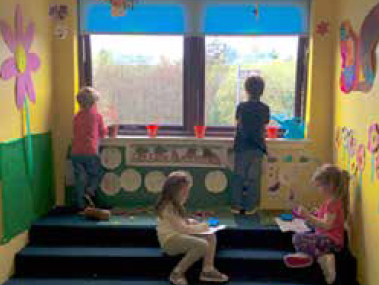 Children at Enchanted Forest, Inverkip use the steps to look out the window