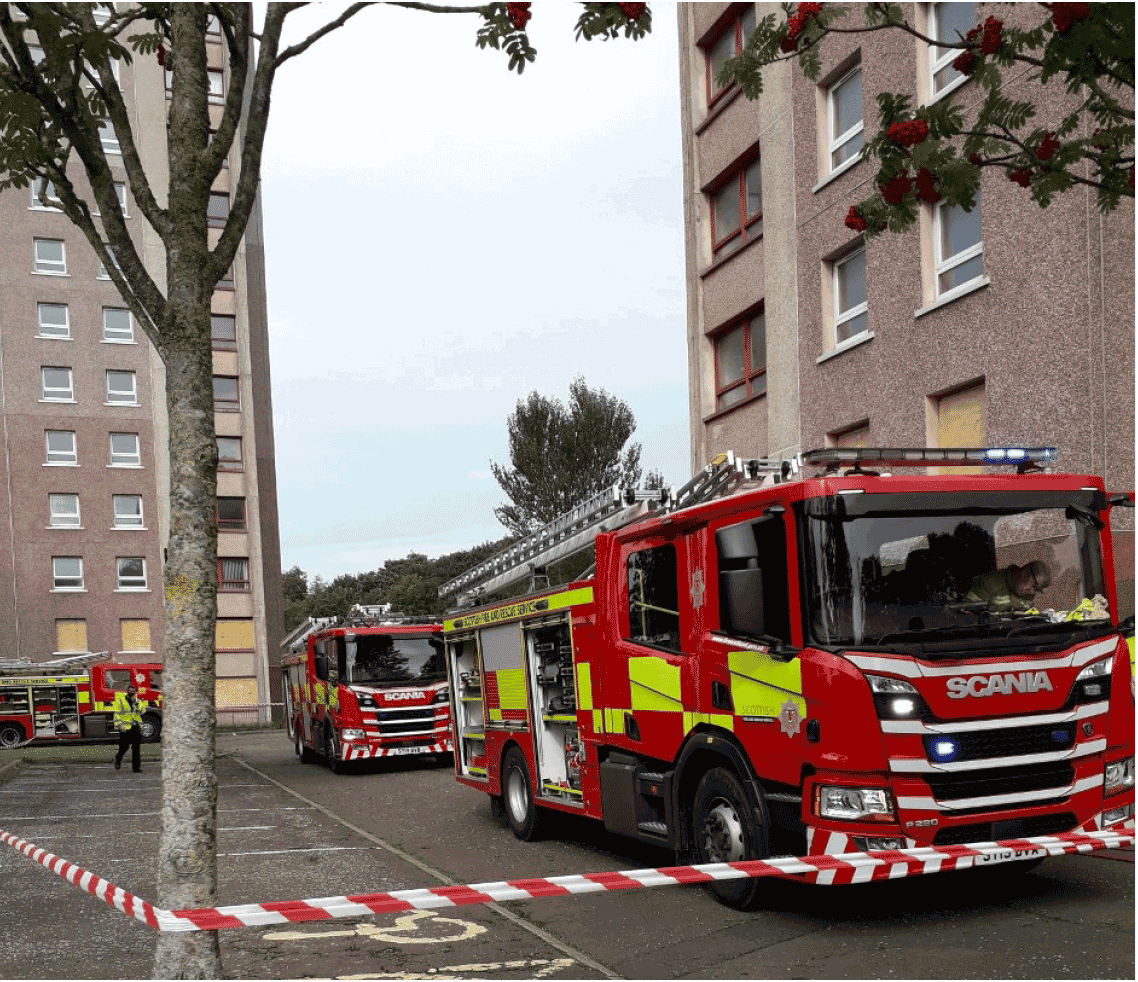This image shows three fire appliances outside two high rise blocks taking part in a exercise