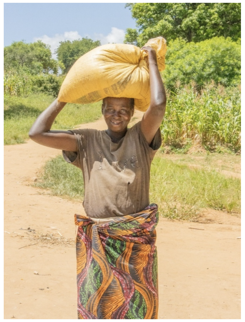 Kelita holds a bag on her head and looks at the camera.