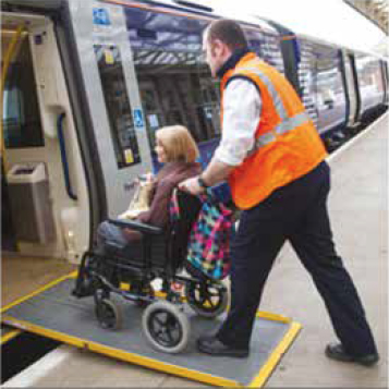Person Using a ramp to board a train Person Using a ramp to board a train