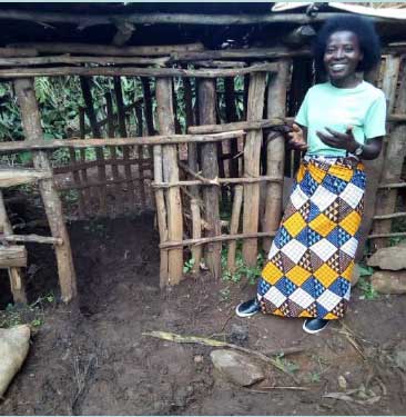Nyiraguhirwa Agathe, adult literacy tutor, at an adult's learner's home