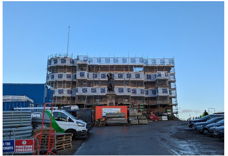 Inverness Castle council administration building under construction with a statue in front. 
