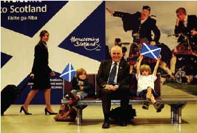 Minister for Enterprise, Jim Mathers unveils the new airport images that welcome all tourists to Scotland in the year of Homecoming.