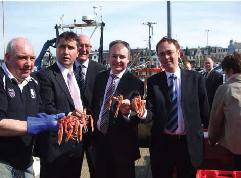 Scotland's Fisheries Secretary, Richard Lochhead on a visit to Stornoway shows off some fresh caught langoustines.