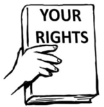 A hand holding a book with ‘Your Rights’ written on the cover.
