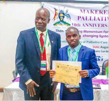 Dr Jean Pierre Sibomana, University of Rwanda clinical lecturer, receiving a certificate of recognition for the Cairdeas partnership with Rwanda (Small Grants Programme project) at the MMPCU 10th anniversary conference in Uganda.