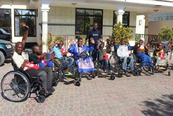 Individuals with mobility issues from local communities in Tabora region, Tanzania, in receipt of good quality wheelchairs via Just Wheels, Perthshire,