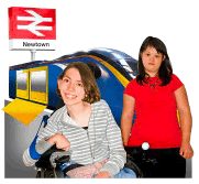 A woman using a wheelchair and her friend on a train platform.