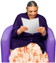 A woman sitting reading a document