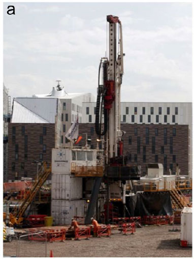 Figure 3: (a) Geothermal drilling in Newcastle upon Tyne in 2011 (b) Geothermal wellhead at the Southampton scheme. This photo was taken during maintenance work; usually the wellhead is encased in insulation and is even less conspicuous.