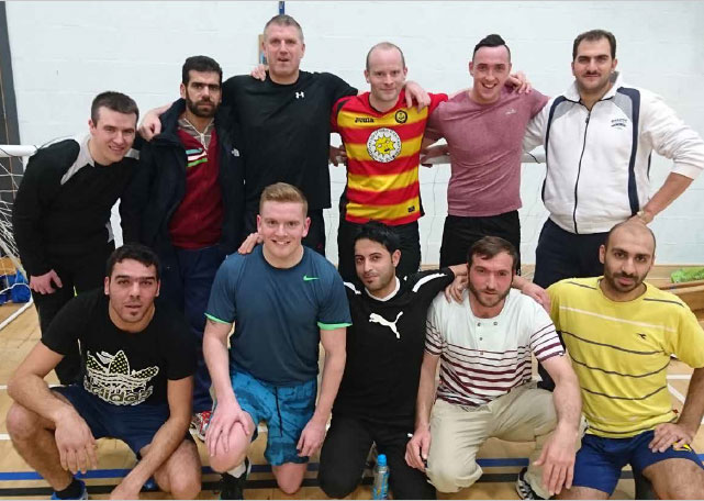 Friendly football match between Rothesay police officers and refugees.
