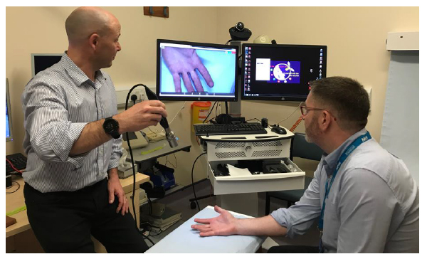Patient in a physiotherapy hand clinic having a video consultation with a specialist hand surgeon