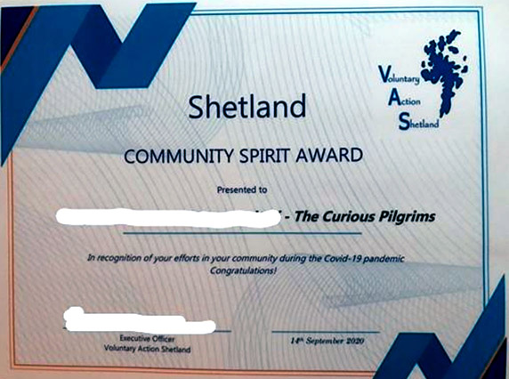 A picture of a certificate showing the community spirit award given to Curious  Pilgrims by Voluntary Action Scotland in recognition of their efforts.