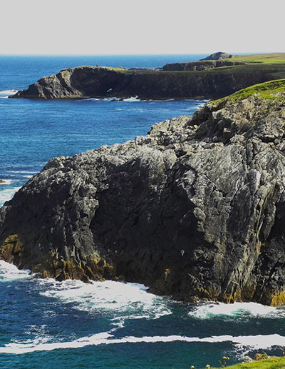A photo of cliffs and the sea which is part of the Galson area coastline.