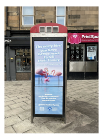 Example of a phone kiosk poster showing a family of birds close together.