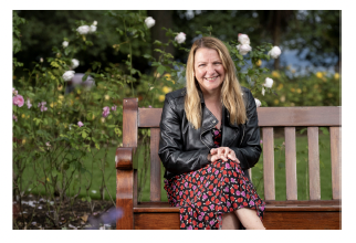 A woman sitting on a park bench.