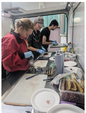 Staff working with tissue samples inside SMASS trailer.