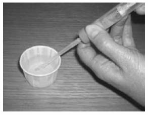 Put the end of the tube into the urine in the beaker and pull back the syringe to fill it