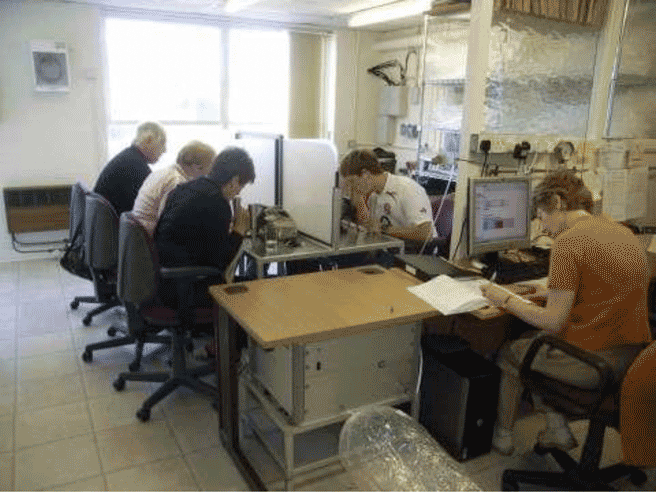 This figure shows odour analysis taking place (a nalophane sample bag is in the foreground).